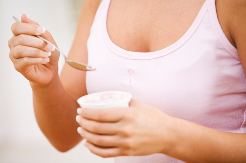 Woman eating yogurt_iStock_000005817765Small