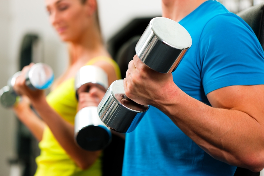 couple in gym exercising with dumbbells_iStock_000015463854Small