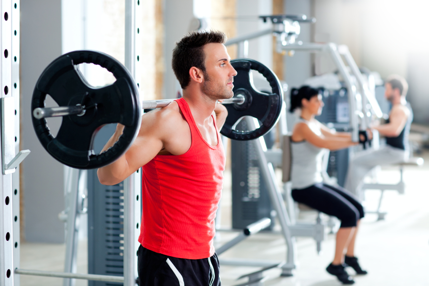 man with dumbbell weight training equipment gym