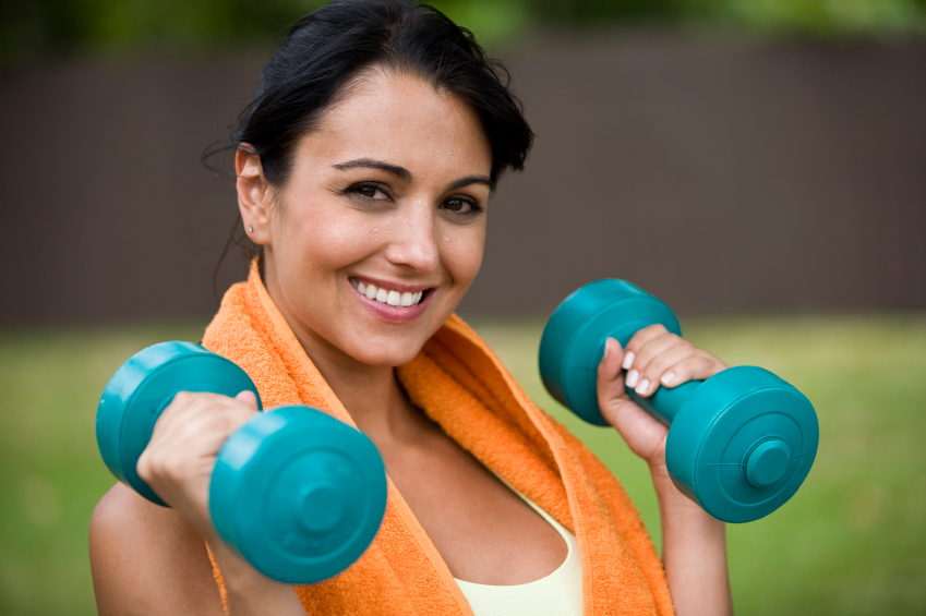 Young female holding dumbbells