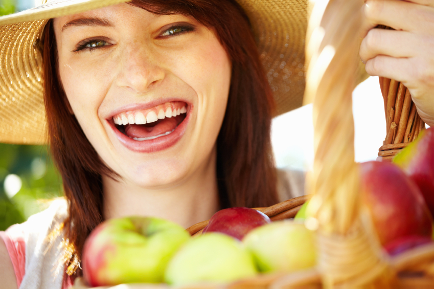 Woman with basket full of apples