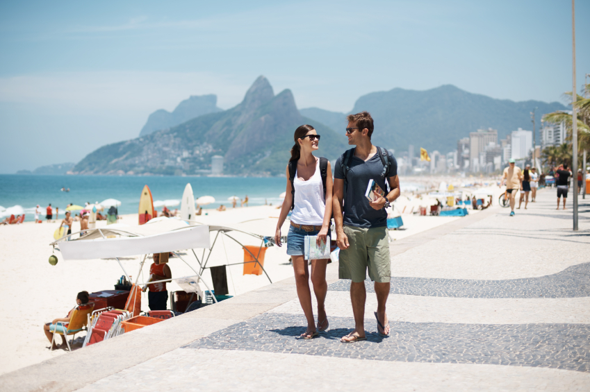 couple walking beside the beach