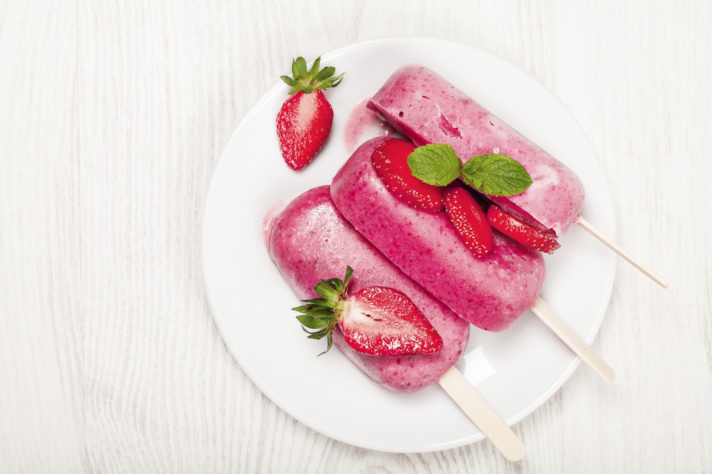 Strawberry popslice icecream on light wooden background