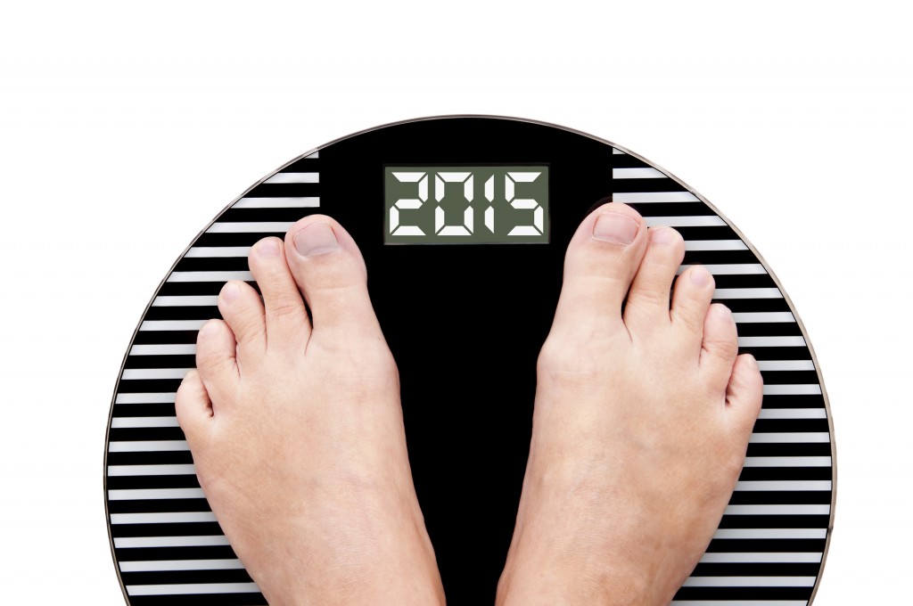 2015 feet on a weight scale isolated on white background