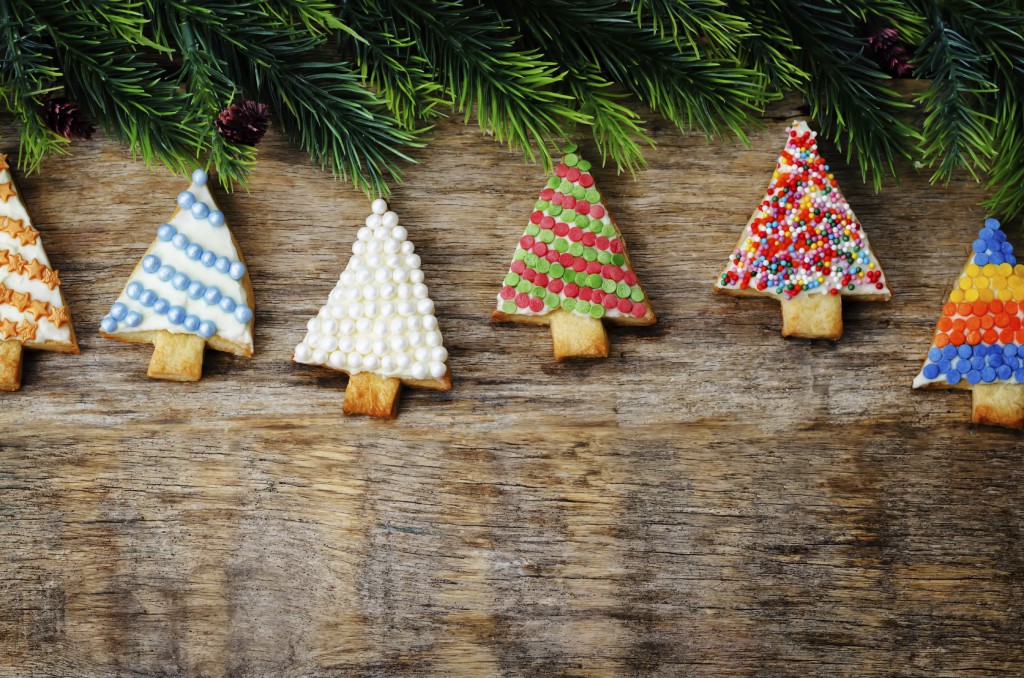 colored Christmas tree cookies on a dark wood background. toning. selective Focus